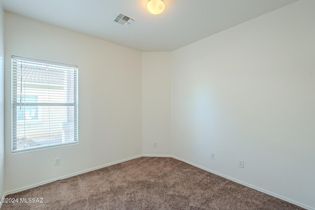 unfurnished bedroom with washing machine and clothes dryer, a closet, and carpet