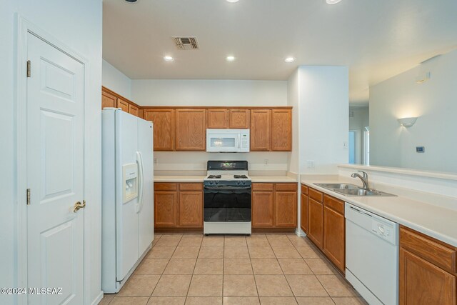 kitchen featuring kitchen peninsula, sink, light tile patterned floors, and white appliances