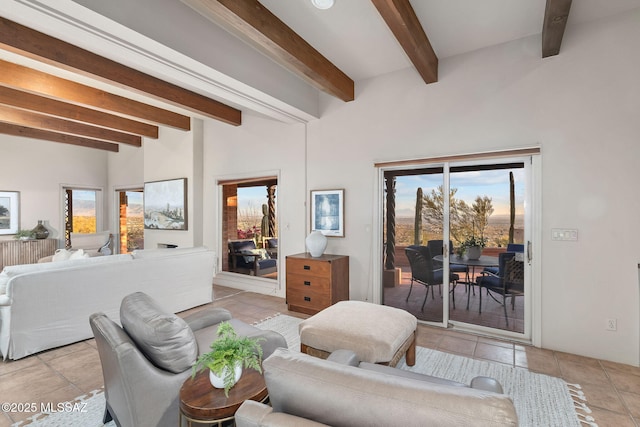 living room with a healthy amount of sunlight, light tile patterned floors, and beamed ceiling