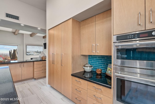 kitchen with tasteful backsplash, visible vents, dark countertops, beamed ceiling, and stainless steel double oven