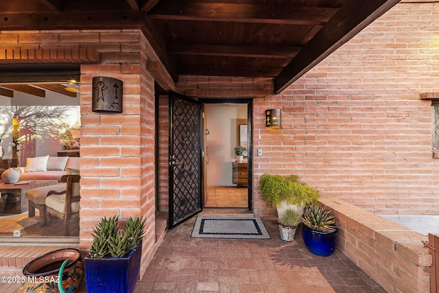 entrance to property featuring brick siding