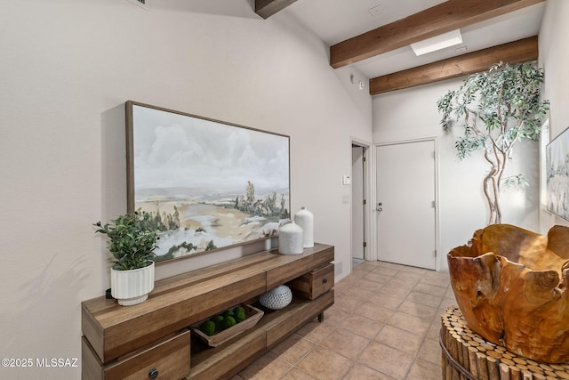 foyer featuring light tile patterned flooring and beam ceiling