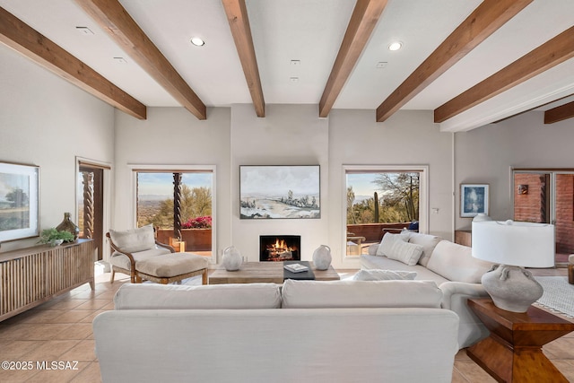 living area with a warm lit fireplace, recessed lighting, a wealth of natural light, and light tile patterned flooring