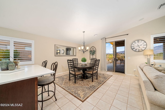 dining room featuring vaulted ceiling, an inviting chandelier, and light tile patterned floors