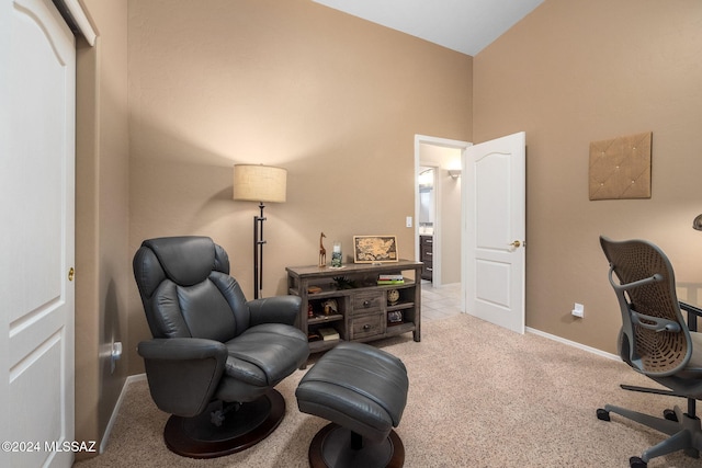 carpeted home office with vaulted ceiling