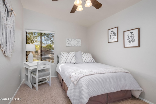 carpeted bedroom featuring ceiling fan and vaulted ceiling