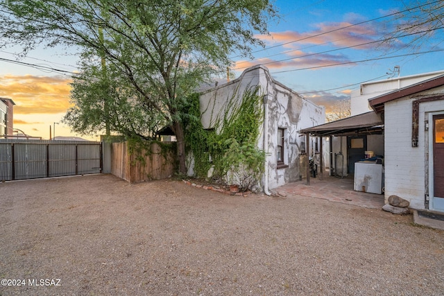 property exterior at dusk featuring washer / dryer