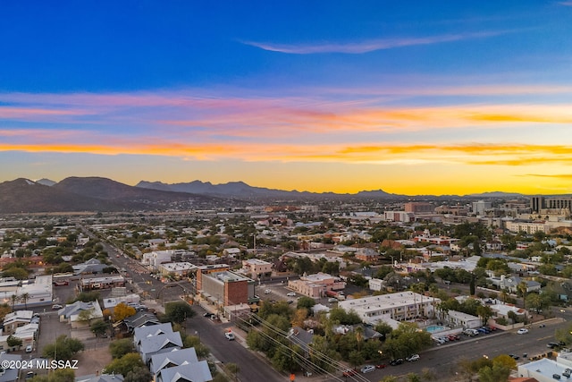 aerial view at dusk featuring a mountain view