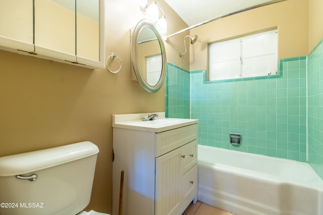 full bathroom featuring vanity, tiled shower / bath combo, and toilet