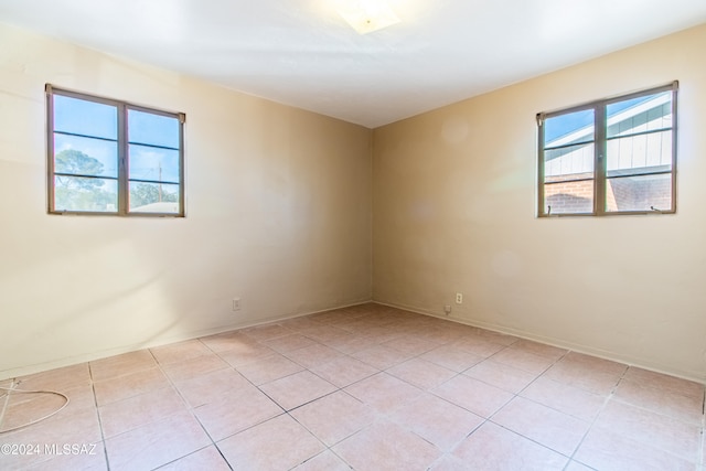 spare room with light tile patterned flooring