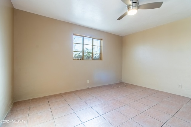 empty room featuring ceiling fan and light tile patterned flooring