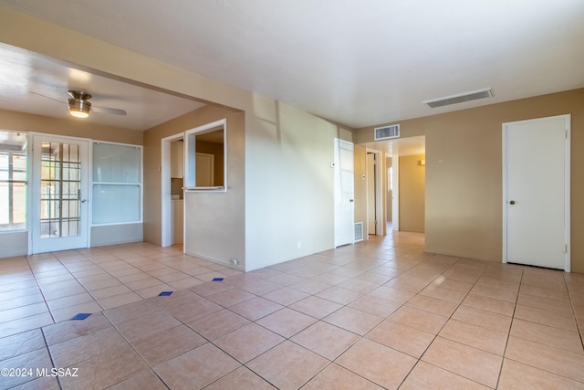 tiled spare room featuring ceiling fan