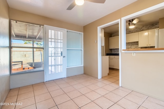 interior space featuring ceiling fan and light tile patterned floors