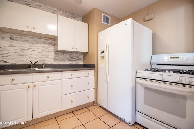 kitchen featuring white appliances, white cabinets, sink, decorative backsplash, and light tile patterned flooring