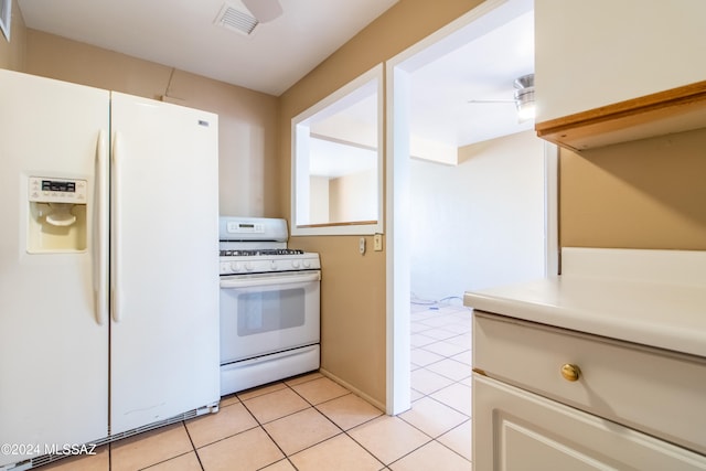 kitchen featuring white cabinetry, white appliances, and light tile patterned floors