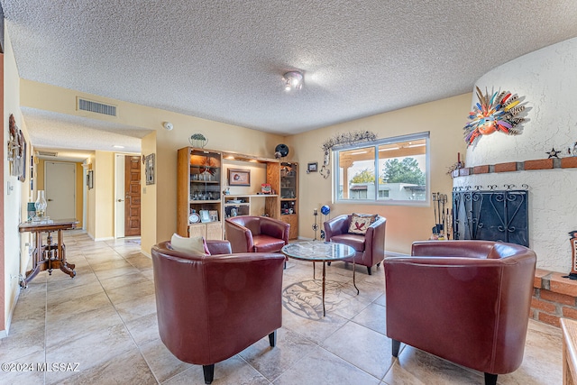 living room featuring tile patterned floors, a fireplace, and a textured ceiling