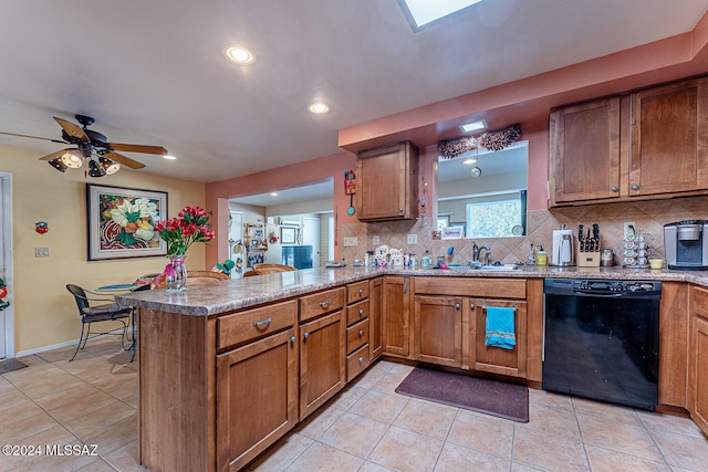 kitchen featuring kitchen peninsula, backsplash, sink, light tile patterned floors, and black dishwasher