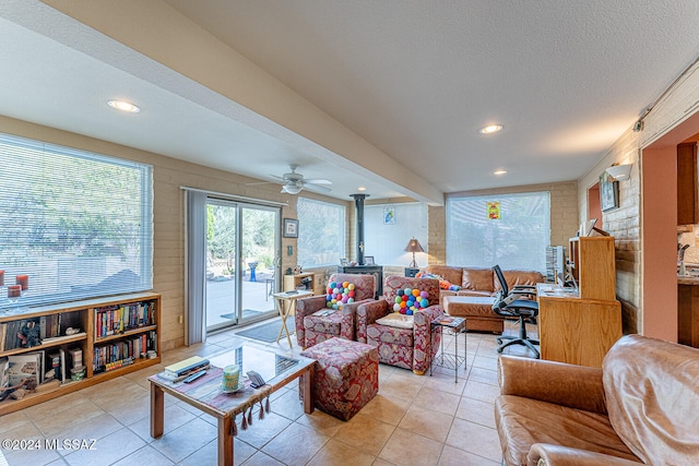 tiled living room featuring a textured ceiling and ceiling fan