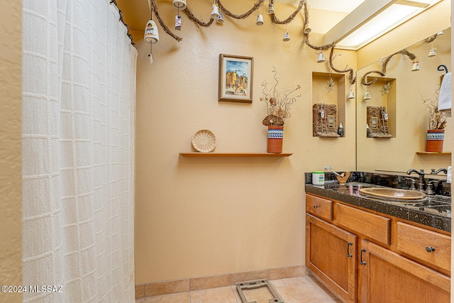 bathroom featuring tile patterned flooring and vanity