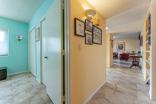 hallway featuring a textured ceiling