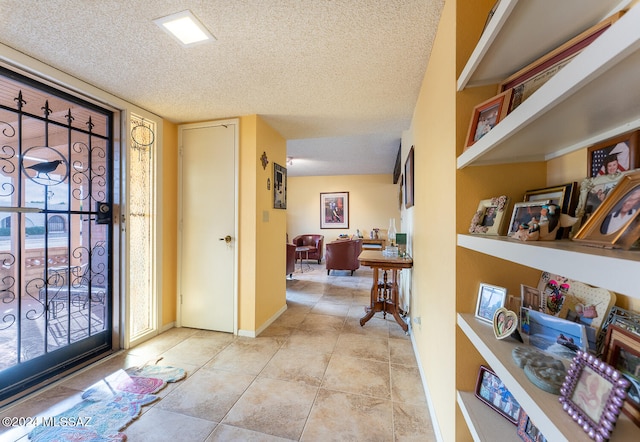 tiled entryway featuring a textured ceiling