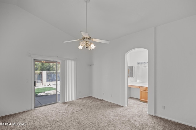 spare room with light carpet, ceiling fan, and lofted ceiling