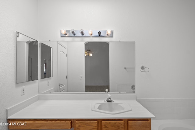 bathroom featuring vanity and a washtub