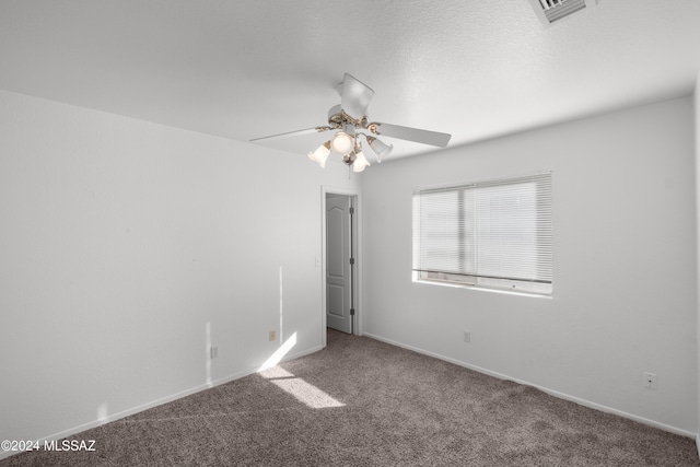 spare room featuring carpet floors and ceiling fan