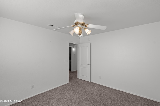 carpeted spare room with ceiling fan