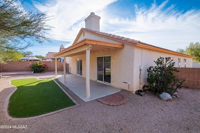 rear view of property featuring a patio