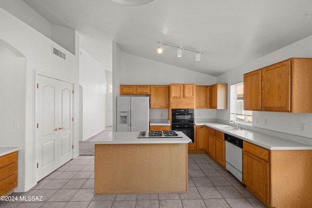 kitchen with a kitchen island, white appliances, light tile patterned floors, and vaulted ceiling