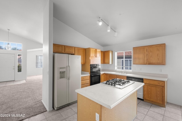 kitchen with white appliances, light tile patterned floors, high vaulted ceiling, a center island, and hanging light fixtures