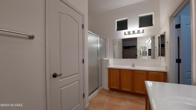 bathroom featuring tile patterned flooring, vanity, and walk in shower