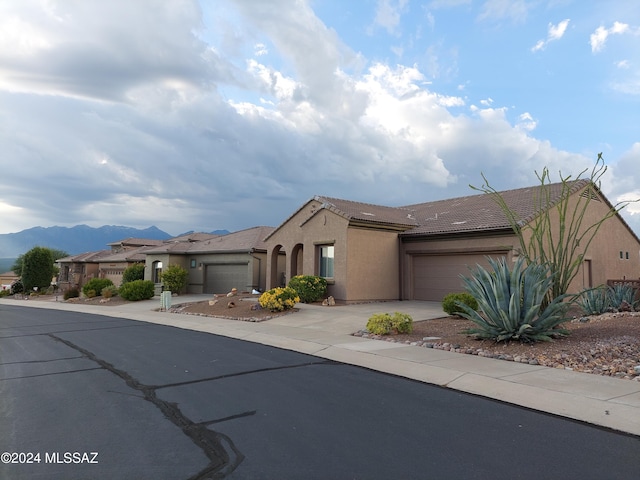 view of front of property featuring a mountain view and a garage