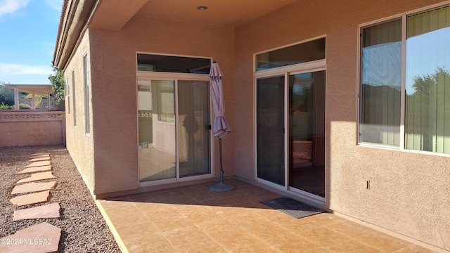 view of exterior entry featuring a patio