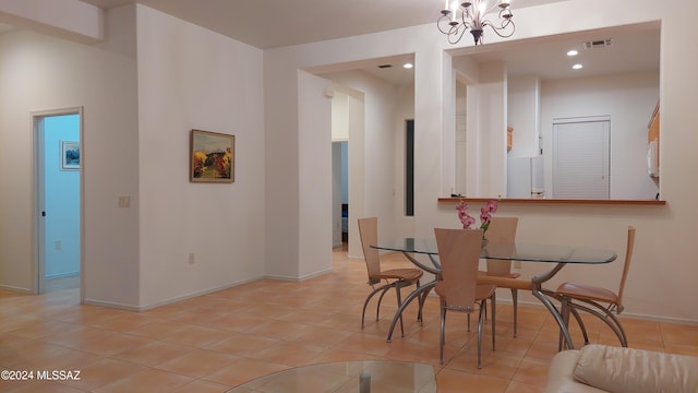 dining space with light tile patterned flooring and a chandelier