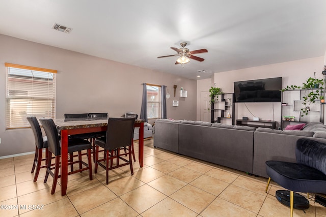 tiled living room featuring ceiling fan