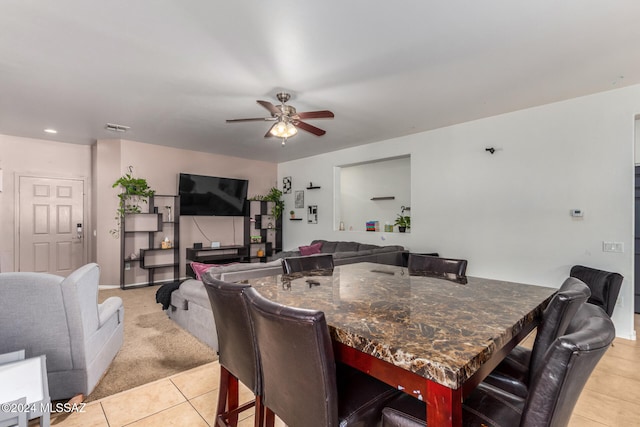 dining space with light tile patterned floors and ceiling fan