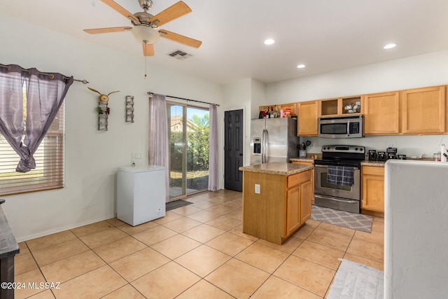 kitchen with ceiling fan, light tile patterned flooring, light stone countertops, and appliances with stainless steel finishes