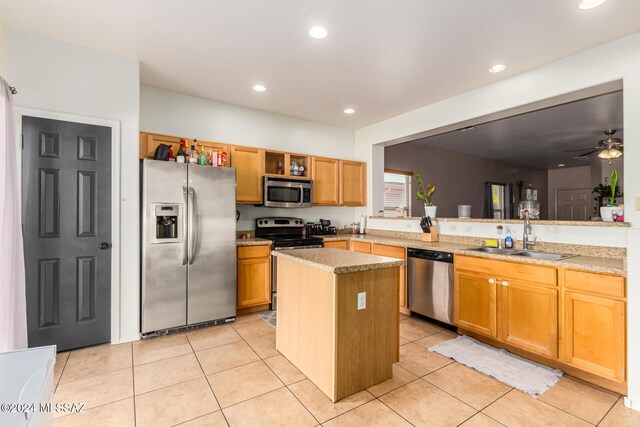 21330 E Reunion Rd, Red Rock, AZ 85145 - kitchen with stainless steel appliances, a sink, light tile patterned floors, a kitchen island, and recessed lighting