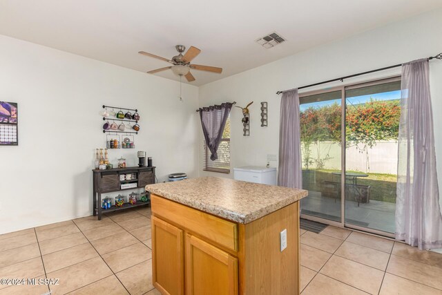 21330 E Reunion Rd, Red Rock, AZ 85145 - kitchen featuring ceiling fan, light tile patterned flooring, a center island, and light countertops