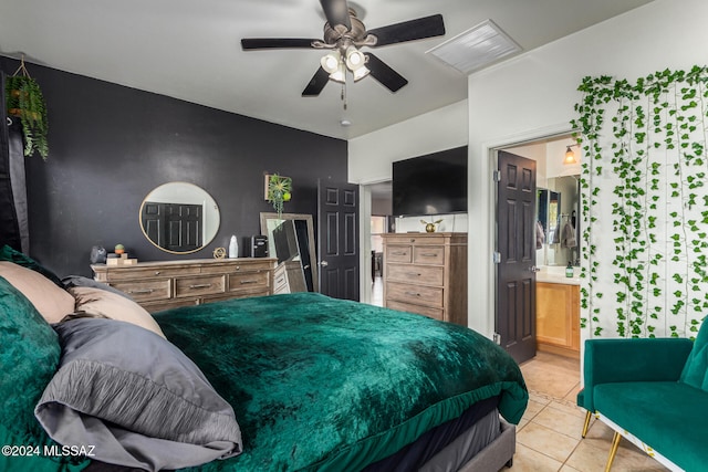 bedroom featuring ensuite bathroom, ceiling fan, and light tile patterned flooring