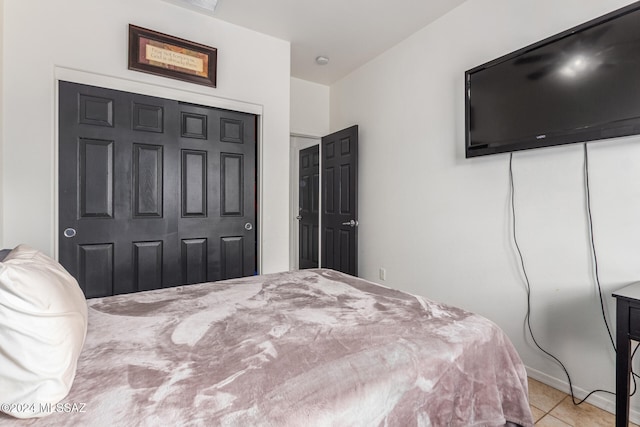 bedroom featuring light tile patterned floors and a closet