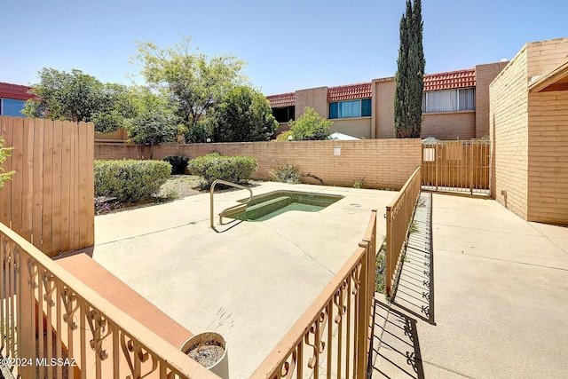 view of patio / terrace featuring an in ground hot tub