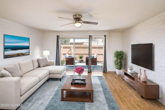 living room featuring ceiling fan and light hardwood / wood-style flooring