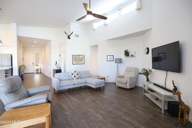 living room with ceiling fan and high vaulted ceiling