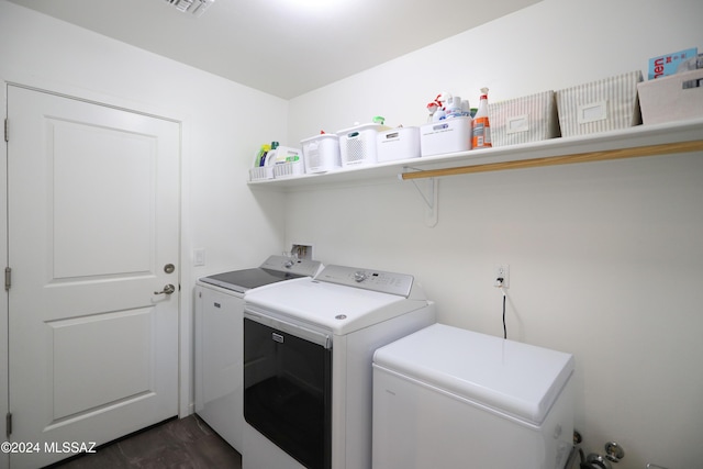 washroom featuring washing machine and dryer and dark hardwood / wood-style floors