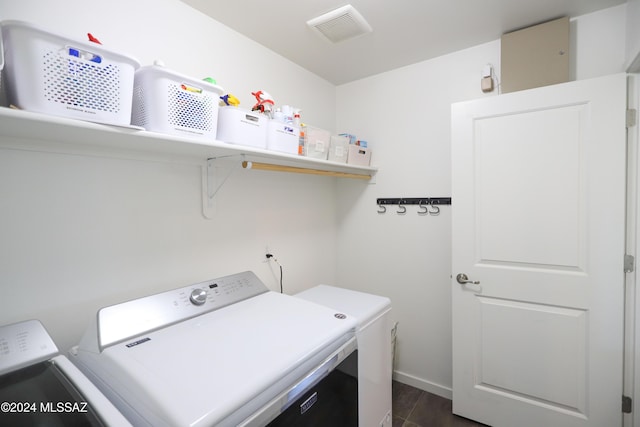 washroom featuring dark hardwood / wood-style floors and washing machine and clothes dryer