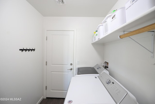 washroom with dark hardwood / wood-style floors and washer and clothes dryer