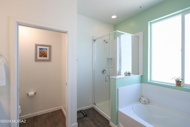 bathroom with toilet and plus walk in shower